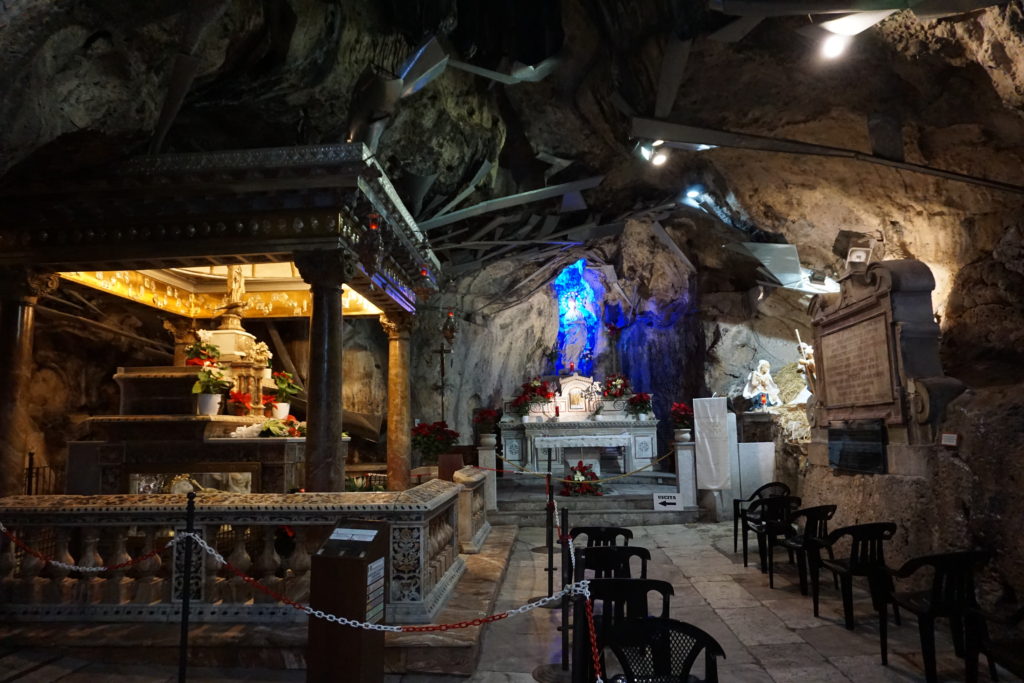 shrine of santa rosalia, inside a cave with metal pipe system on roof.