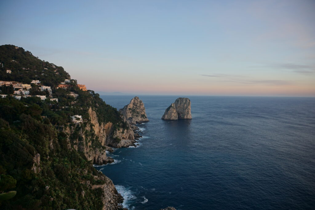 Sunset view of rocks formations in the Mediterranean Sea, as seen from the Island of Capri, Italy.