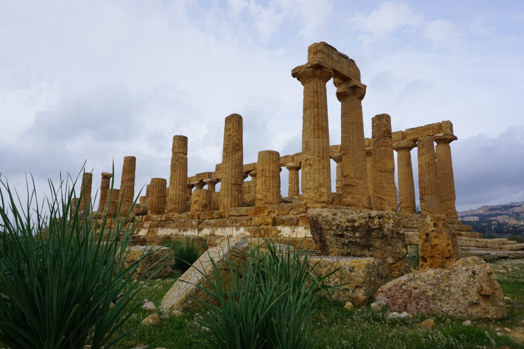 Roman temple ruins at the Valley of the Temples in Agrigento, Sicily. If you're deciding whether to visit Sicily vs the amalfi coast, these ruins are one of many reasons to visit sicily!