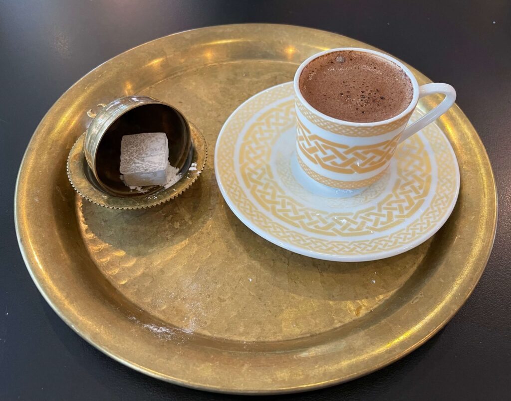 Traditional Turkish Coffee, served on a copper tray and a side of Turkish delight.