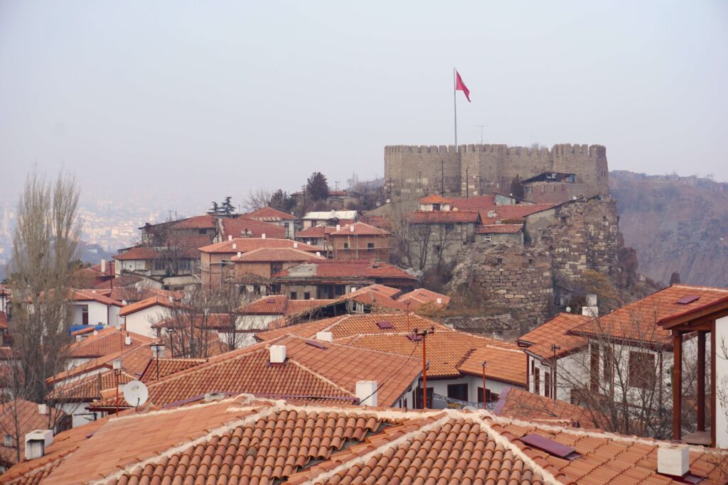 red tiled roofs leading to a stone castle