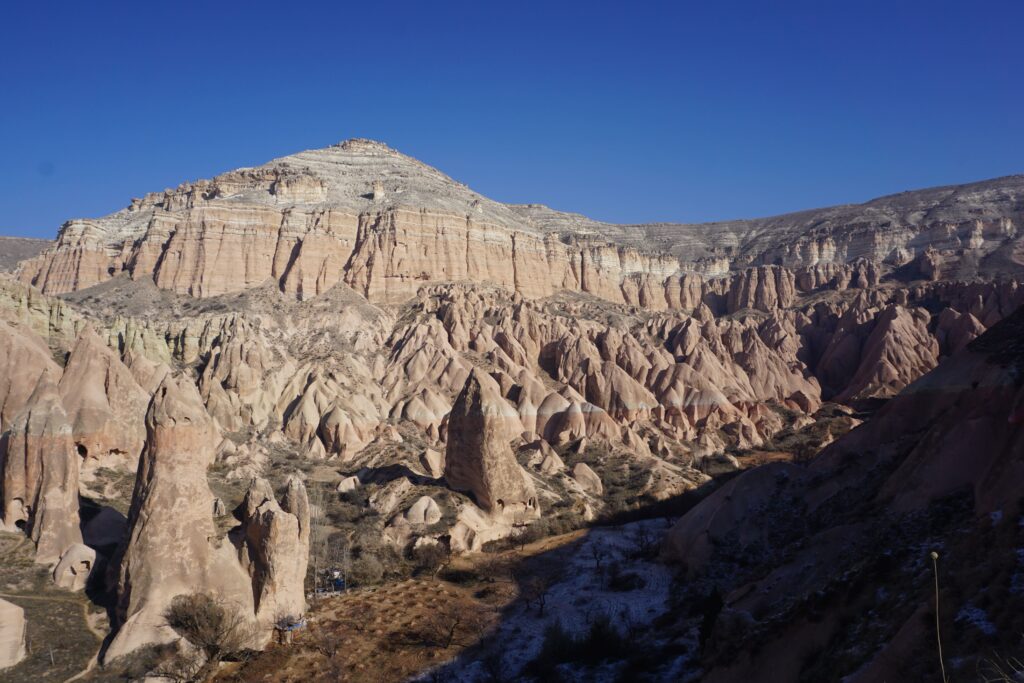 cappadocia in january landscape. fairy chimneys with a dusting of snow.