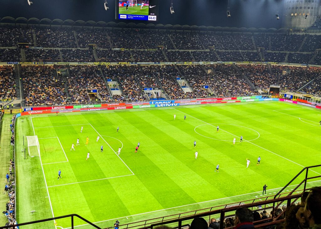 stadium soccer field with players mid-game.