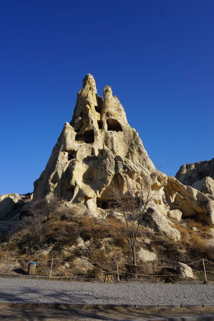 large rock outcropping with dwellings cut into it