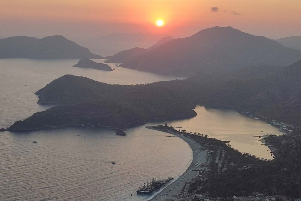 Sunset over mountains and water at the blue laggoon in Turkey.