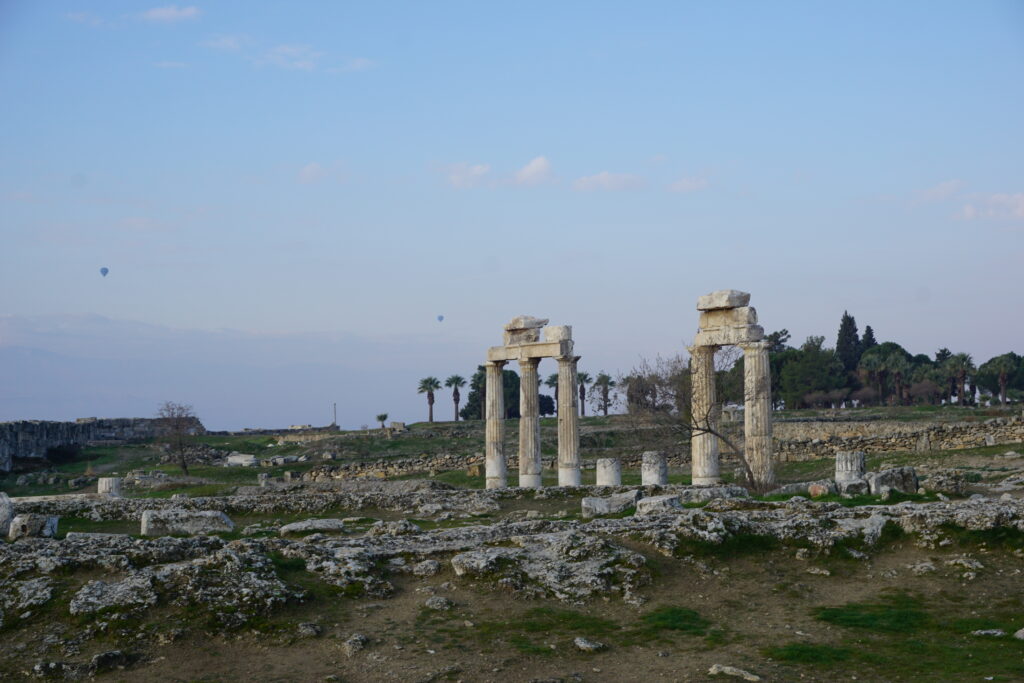 free-standing cloumns are all that remain of the ancient city of hierapolis, a historic landmark in Turkey.