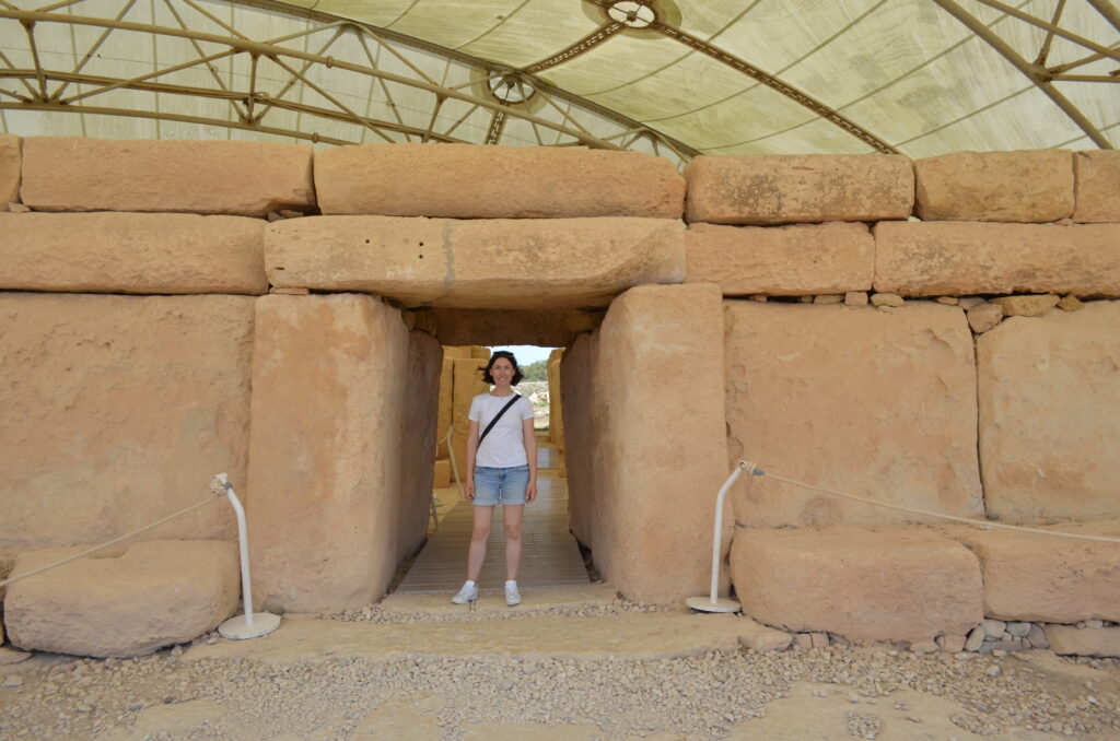 the author, Tamar, standing in front of the entrance to one of Malta's megalithic temples.