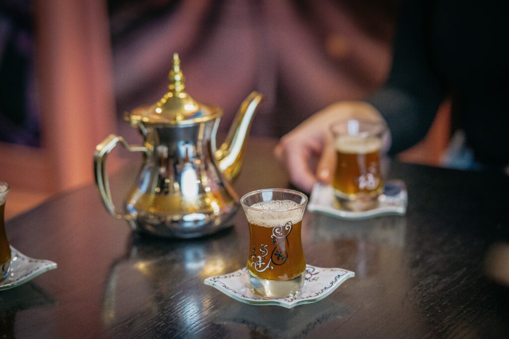 a Tea Set sits on a table, including tulip-shaped tea glasses full of Turkish tea. These sets make great souvenirs when in Turkey.