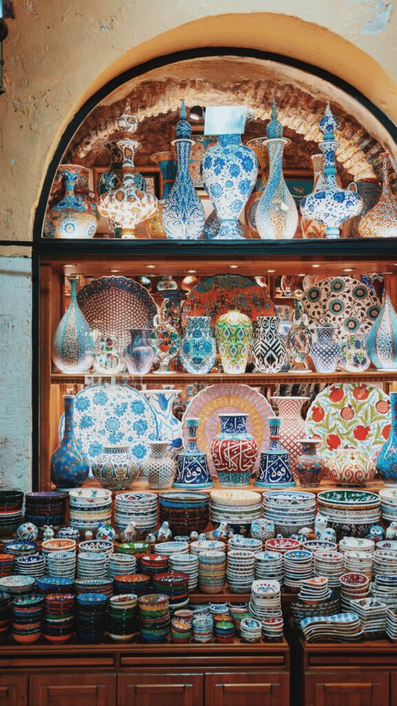 Turkish Ceramics of all sizes, from lamps and decorative plates to small bowls, with colorful and intricate patterns, adorn a dhop window.