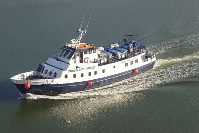 Aerial view of the 'Dublin Bay Cruises' vessel, a contender for the best boat Dublin boat tour, cutting through calm waters with its white and blue exterior prominently displayed.