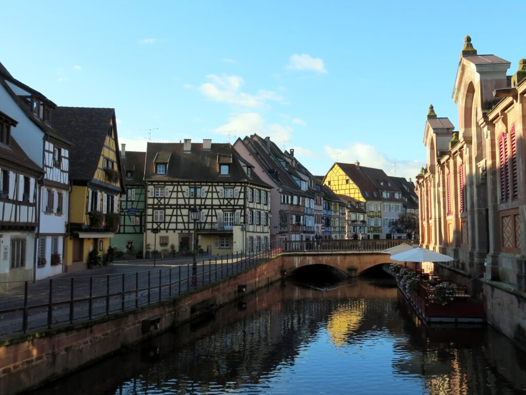 A river in Colmar flanked by colofrul half-timbered houses. 