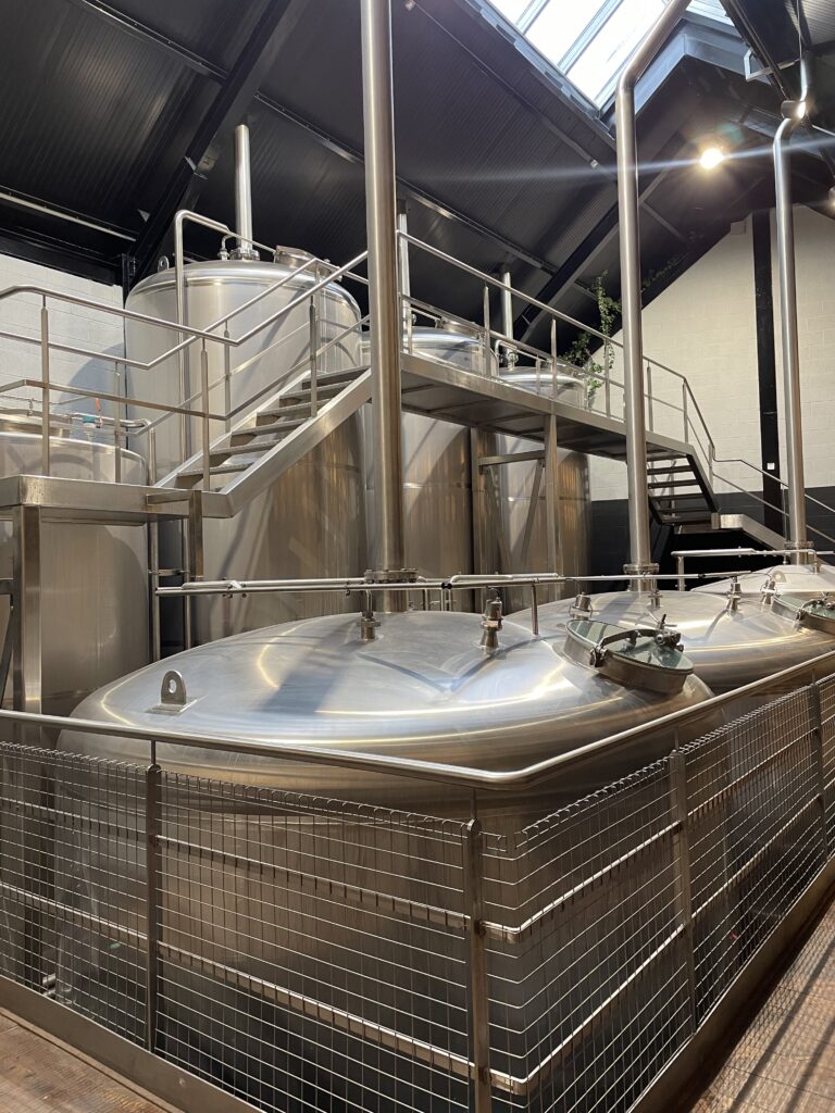 Brewery interior with stainless steel tanks. Beer production equipment. Industrial brewing.